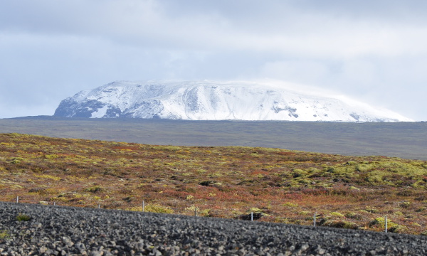 a snowy mountain with barren plains in front in Thingvellir National Park, Iceland